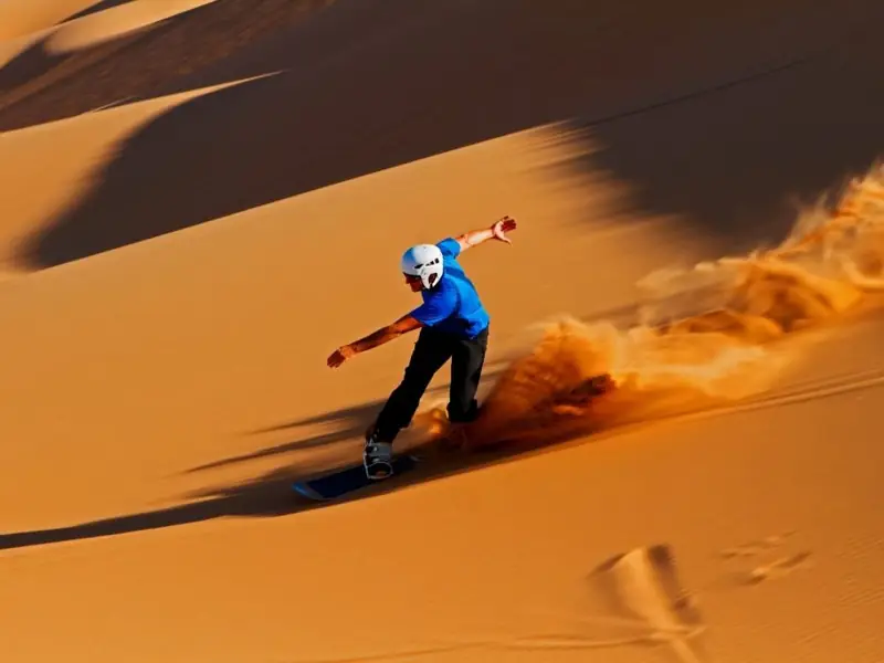 Sandboarding down a dune near Merzouga